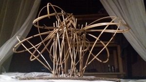 Contemporary bamboo sculpture inspired by organic architecture, set against a dark tropical backdrop.